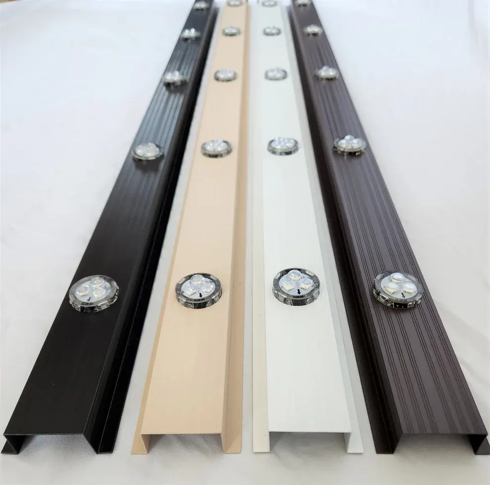 Close-up of white aluminum permanent lighting track mounted flush against white vinyl fascia and soffit
