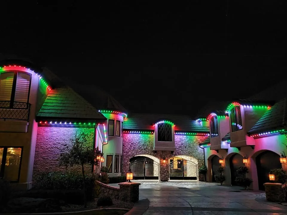 Multicolour permanent lights on a craftsman home with a covered porch