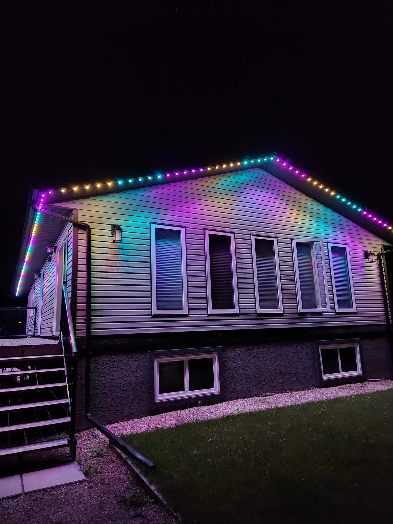 Rainbow multicolour permanent LED lighting on a bungalow roofline